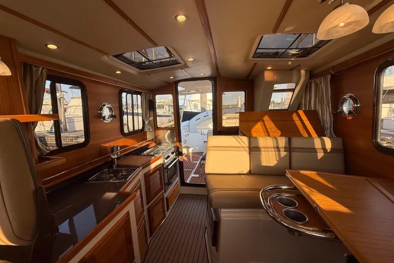  Yacht Photos Pics Luxurious interior of 2024 Ranger Tugs R31CB boat with elegant wood finishes.