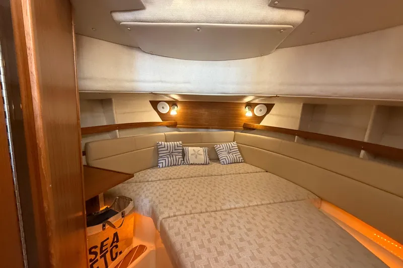  Yacht Photos Pics 2024 Ranger Tugs R31CB cabin interior with cozy bed and ambient lighting.