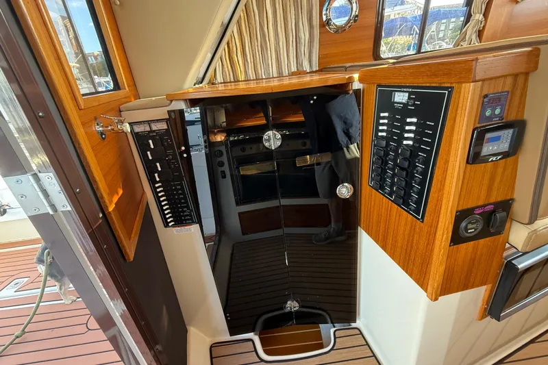  Yacht Photos Pics 2024 Ranger Tugs R31CB interior with control panels and wood finish.