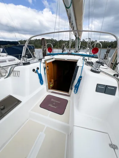 Alacrity Yacht Photos Pics 1998 Saga 43 sailboat cockpit with open cabin door, blue ropes, and scenic marina view.