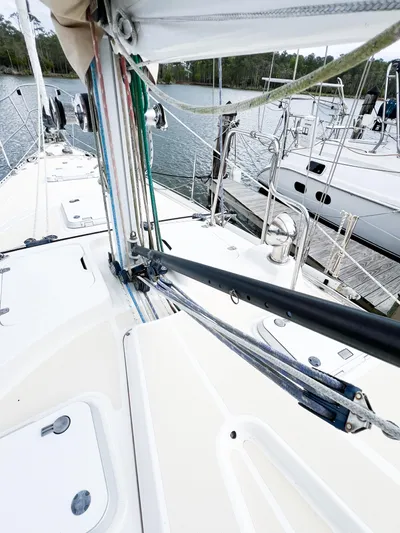 Alacrity Yacht Photos Pics 1998 Saga 43 sailboat deck with rigging and docked boats in background.