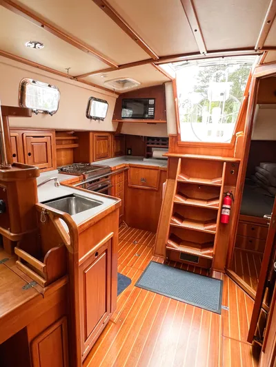 Alacrity Yacht Photos Pics Interior of 1998 Saga 43 sailboat with wooden cabinetry and modern kitchen amenities.