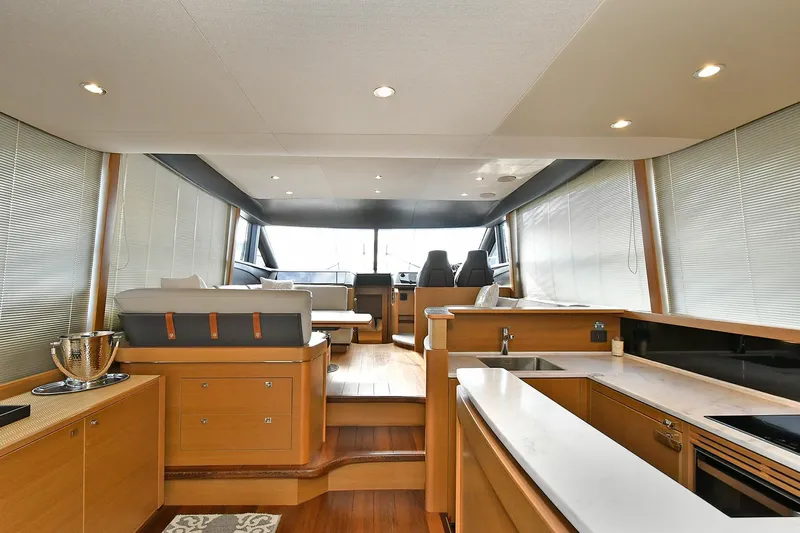 "about Time" Yacht Photos Pics Luxurious interior of 2016 Princess 52 Flybridge Yacht with modern kitchen and seating area.