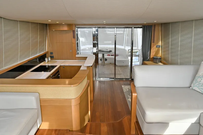 "about Time" Yacht Photos Pics Luxurious interior of a 2016 Princess 52 Flybridge Yacht with modern kitchen and seating area.