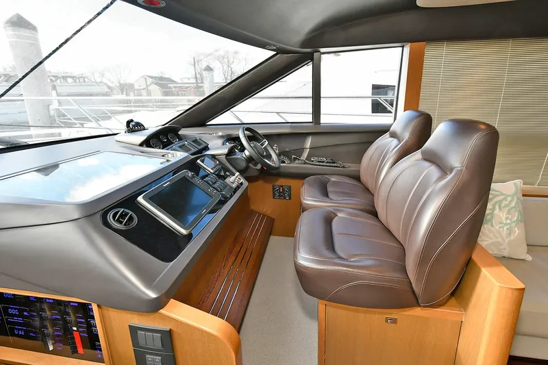 "about Time" Yacht Photos Pics Interior of 2016 Princess 52 Flybridge Yacht with leather seats and modern dashboard.