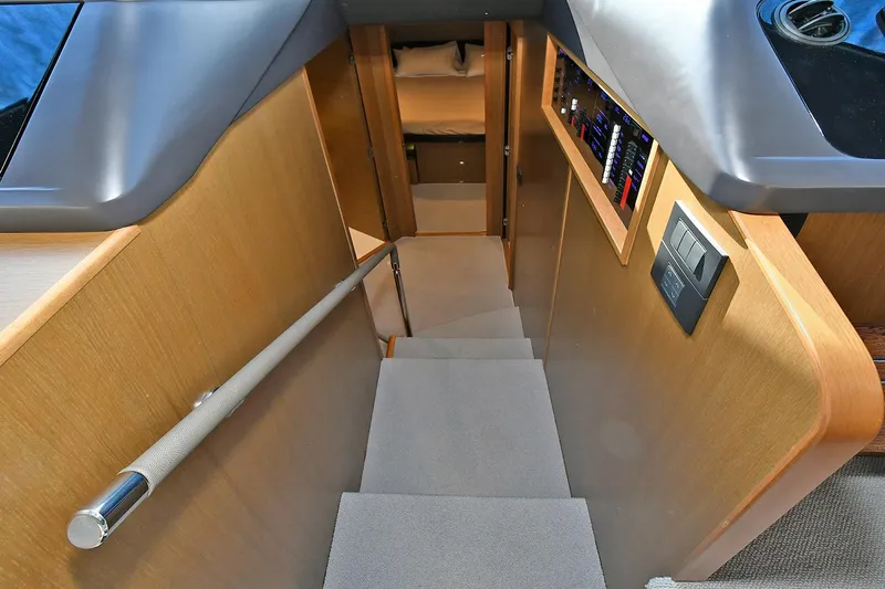 "about Time" Yacht Photos Pics Staircase inside 2016 Princess 52 Flybridge Yacht with wooden finish and handrail.