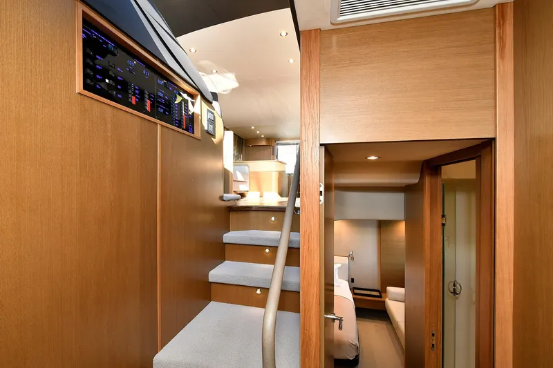 "about Time" Yacht Photos Pics Interior of 2016 Princess 52 Flybridge Yacht with wooden stairs and modern design.