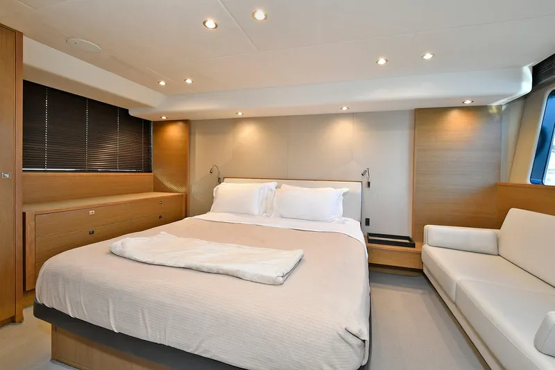 "about Time" Yacht Photos Pics Luxurious bedroom interior on a 2016 Princess 52 Flybridge Yacht, featuring modern design and cozy ambiance.