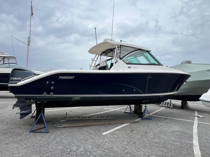 Hot Pursuit Yacht Photos Pics 2016 Pursuit 325 DC boat on stands in a marina setting.