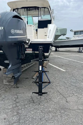 Hot Pursuit Yacht Photos Pics 2016 Pursuit 325 DC boat with Yamaha engine on a trailer in a parking lot.