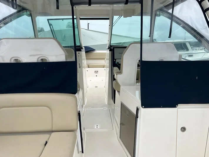 Hot Pursuit Yacht Photos Pics 2016 Pursuit 325 DC boat interior with seating and navigation area.