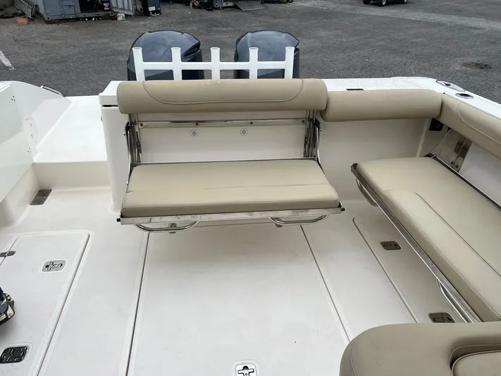 Hot Pursuit Yacht Photos Pics 2016 Pursuit 325 DC boat interior with beige seating and dual outboard motors.
