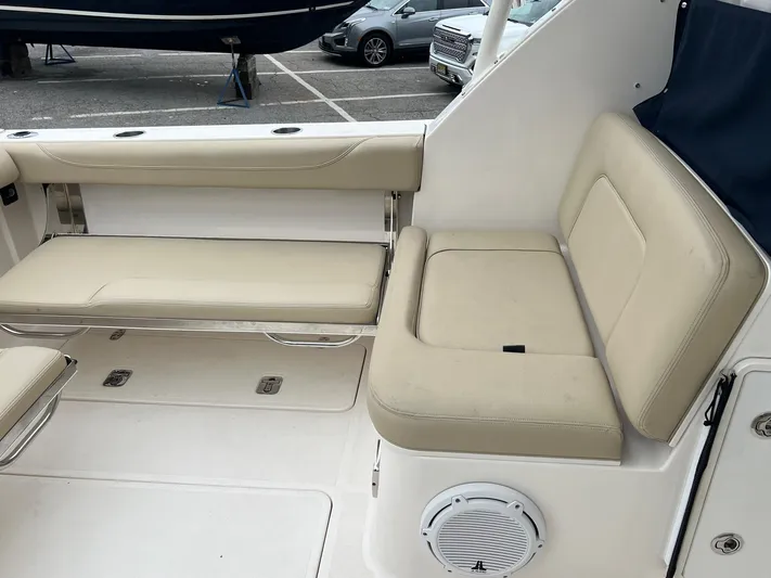 Hot Pursuit Yacht Photos Pics 2016 Pursuit 325 DC boat interior with beige seating and speaker.