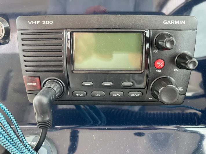 Hot Pursuit Yacht Photos Pics Garmin VHF 200 radio on 2016 Pursuit 325 DC boat dashboard.