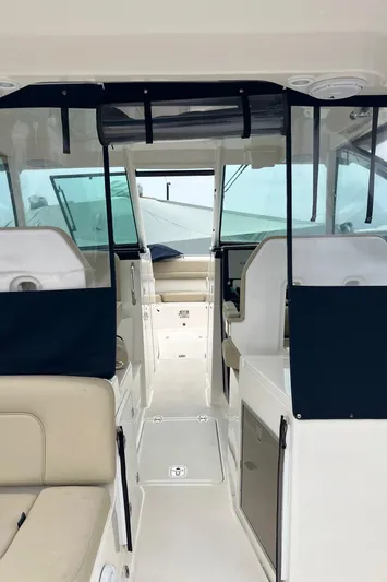 Hot Pursuit Yacht Photos Pics Interior view of 2016 Pursuit 325 DC boat, featuring seating and helm area.