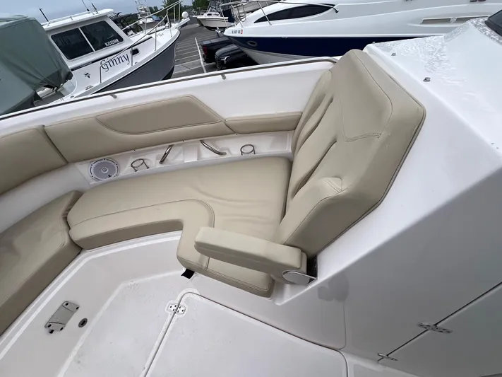Hot Pursuit Yacht Photos Pics 2016 Pursuit 325 DC boat interior with beige seating and cup holders.