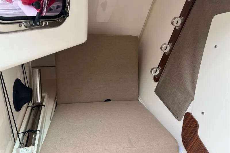 Hot Pursuit Yacht Photos Pics Interior cabin of a 2016 Pursuit 325 DC boat with beige seating.