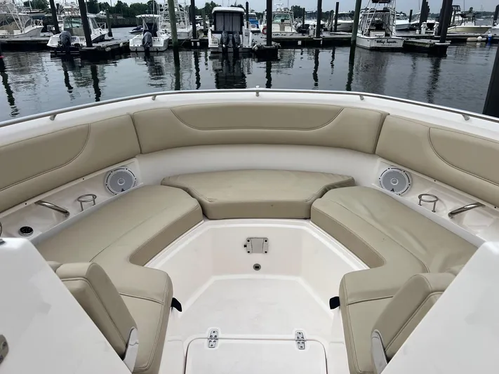 Hot Pursuit Yacht Photos Pics 2016 Pursuit 325 DC boat interior with beige seating at marina.