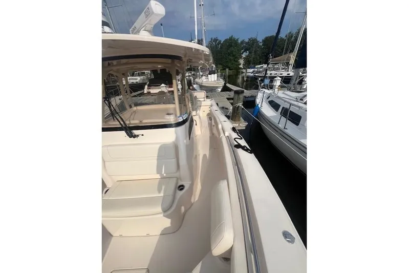  Yacht Photos Pics 2023 Grady-White Canyon 306 boat docked at marina, side view.