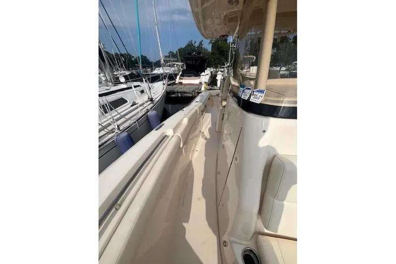  Yacht Photos Pics 2023 Grady-White Canyon 306 boat docked, showcasing sleek design and spacious deck.