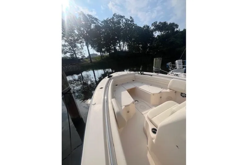  Yacht Photos Pics 2023 Grady-White Canyon 306 boat docked by a serene waterfront.