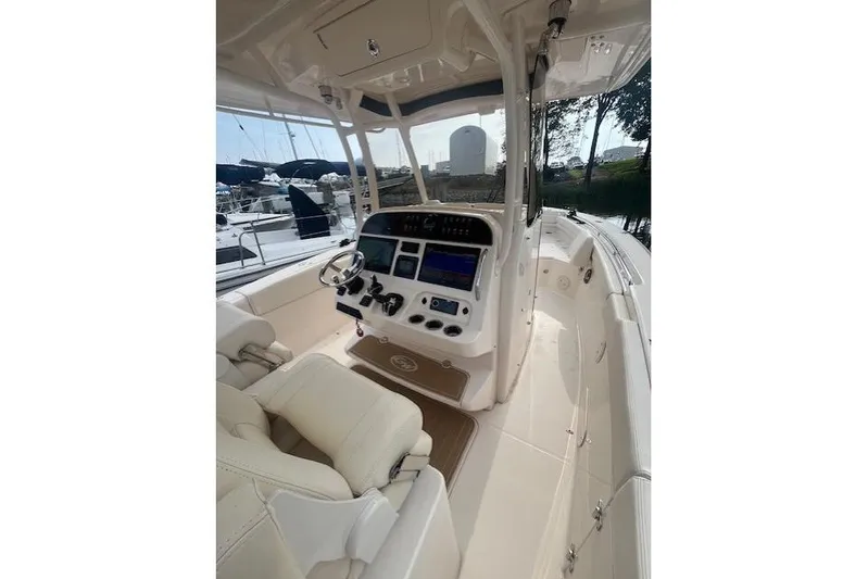  Yacht Photos Pics 2023 Grady-White Canyon 306 boat interior with helm, steering wheel, and navigation controls.