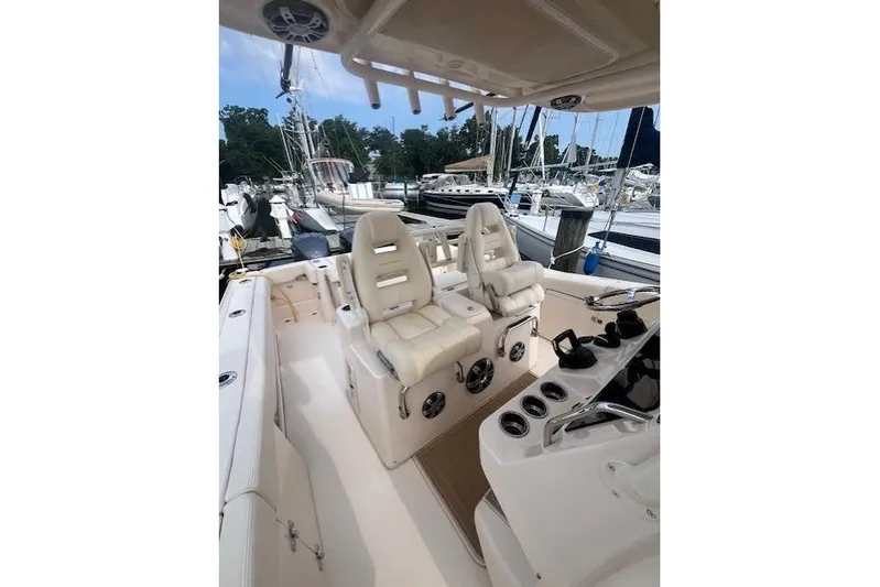  Yacht Photos Pics 2023 Grady-White Canyon 306 boat interior with dual white captain seats at marina.