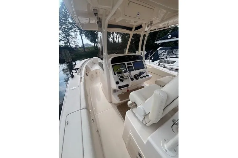  Yacht Photos Pics 2023 Grady-White Canyon 306 boat interior with helm and seating area.
