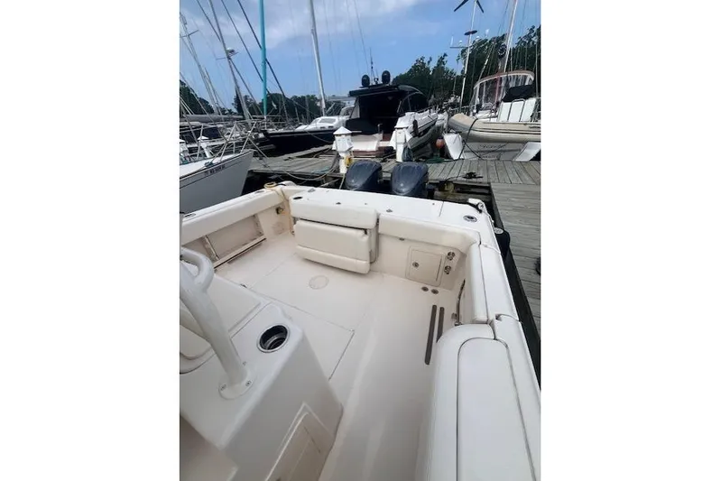  Yacht Photos Pics 2023 Grady-White Canyon 306 boat docked, showcasing spacious deck and seating area.