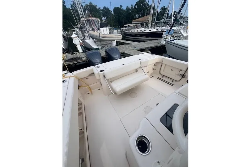  Yacht Photos Pics 2023 Grady-White Canyon 306 boat docked, featuring spacious deck and dual engines.