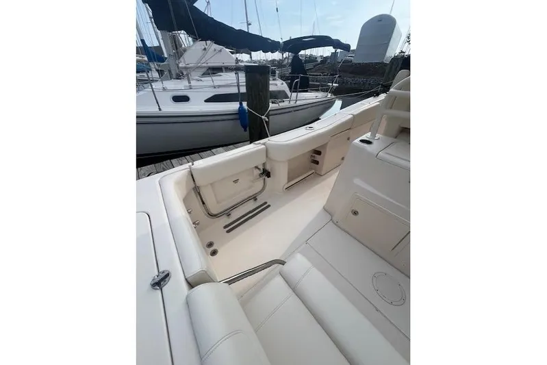  Yacht Photos Pics 2023 Grady-White Canyon 306 boat interior, featuring sleek seating and storage compartments.