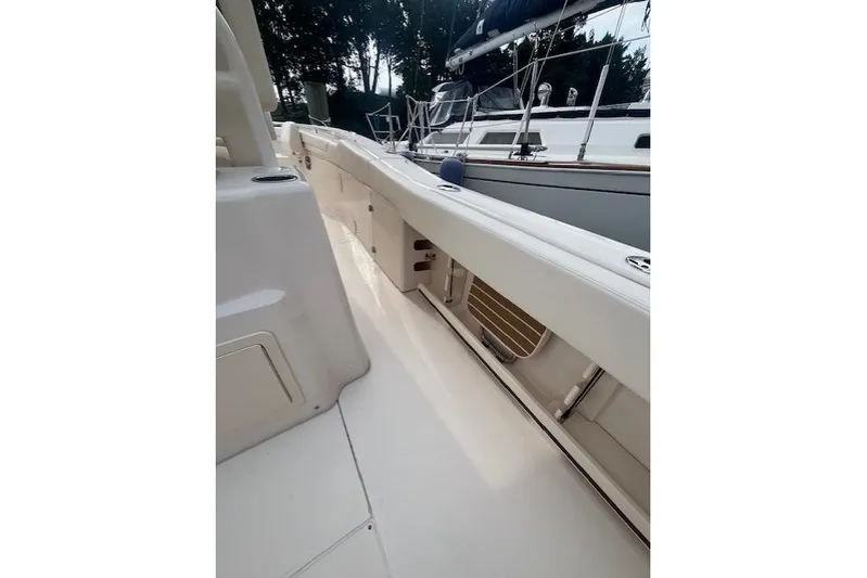  Yacht Photos Pics 2023 Grady-White Canyon 306 boat deck, sleek design, spacious layout, docked beside another vessel.