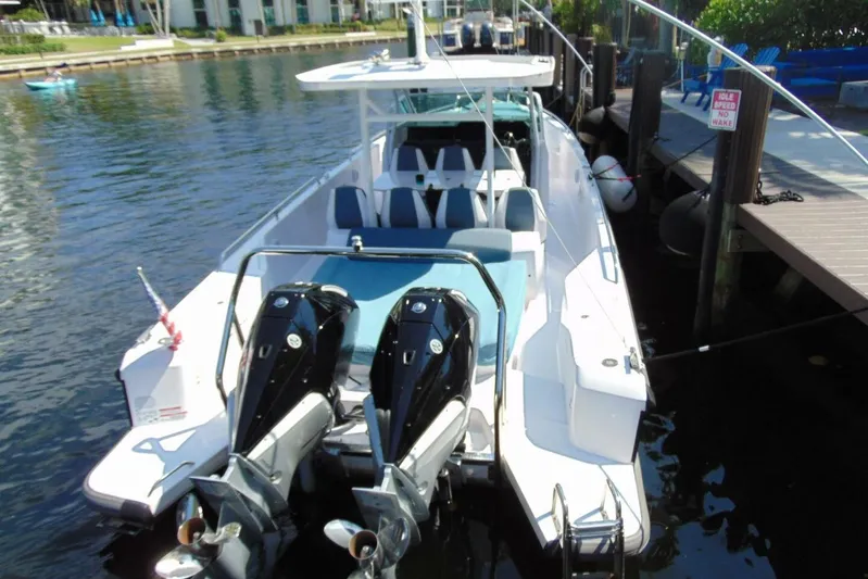 Milan Yacht Photos Pics 2024 Axopar 37 Sun Top boat docked with dual outboard engines.