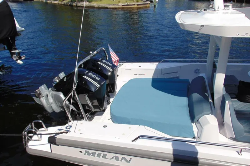Milan Yacht Photos Pics 2024 Axopar 37 Sun Top boat with twin Mercury engines, docked on a sunny day.