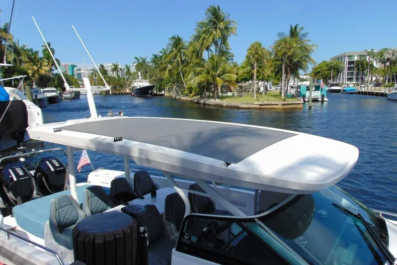 Milan Yacht Photos Pics 2024 Axopar 37 Sun Top boat docked in a tropical marina setting.