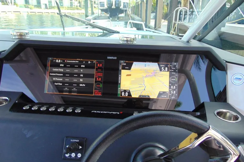 Milan Yacht Photos Pics 2024 Axopar 37 Sun Top dashboard with navigation and control displays.