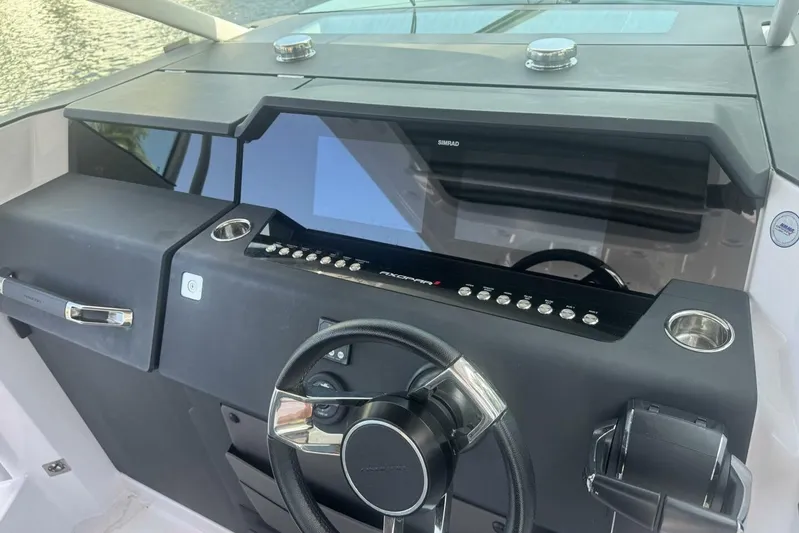 Milan Yacht Photos Pics 2024 Axopar 37 Sun Top dashboard with steering wheel and control panel.