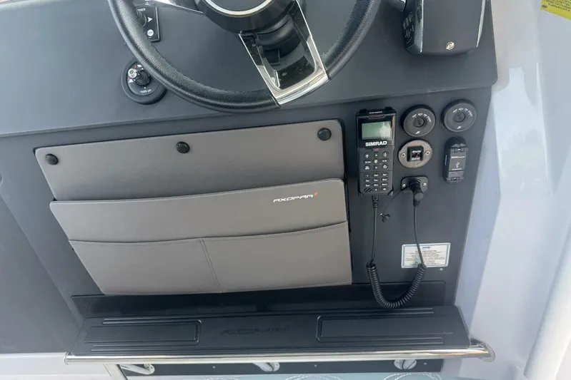 Milan Yacht Photos Pics 2024 Axopar 37 Sun Top dashboard with steering wheel and control panel.