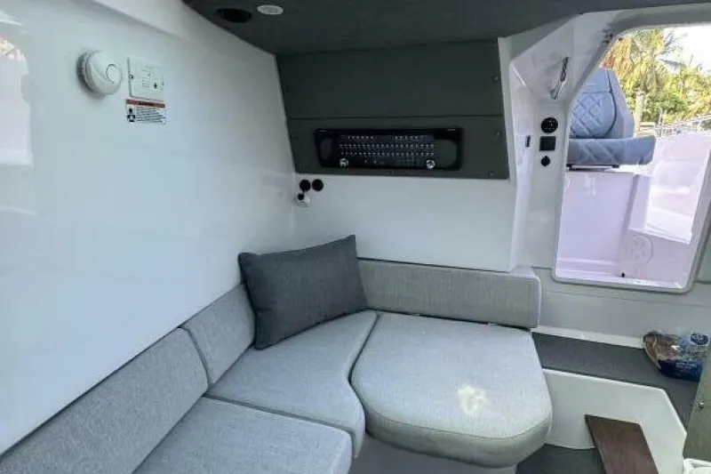 Milan Yacht Photos Pics 2024 Axopar 37 Sun Top interior with modern seating and control panel.