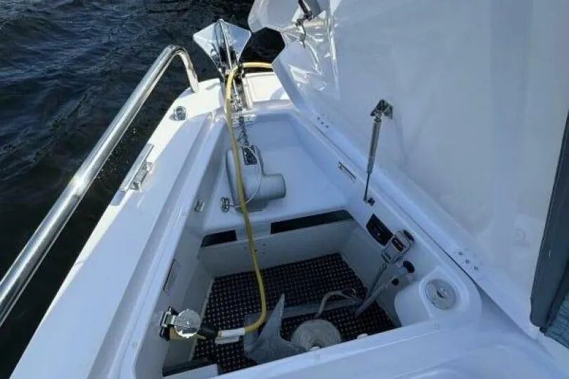 Milan Yacht Photos Pics 2024 Axopar 37 Sun Top anchor compartment with equipment and open hatch.