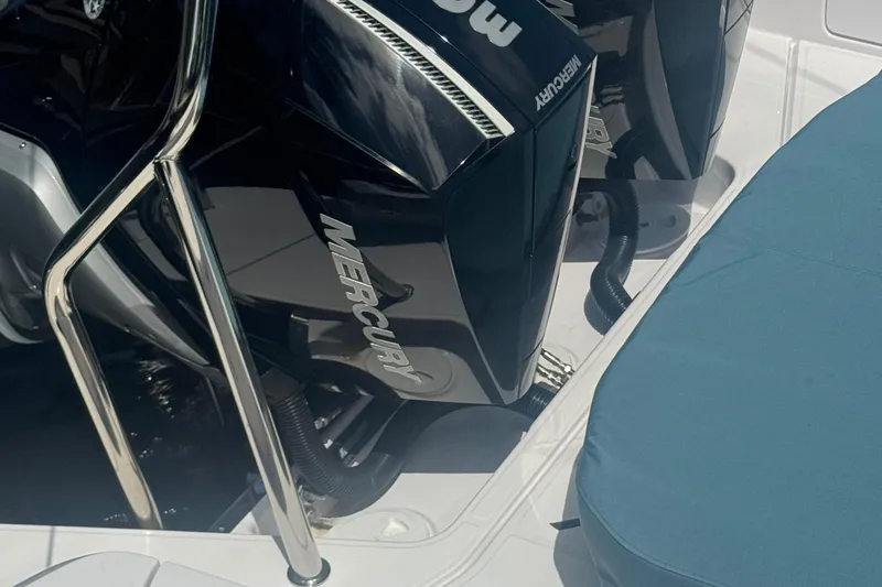 Milan Yacht Photos Pics 2024 Axopar 37 Sun Top with Mercury outboard engines, featuring sleek design and blue seating.