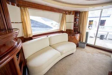 Ghost Rider Yacht Photos Pics Luxurious interior of 2003 Azimut 74 Solar yacht with elegant seating and large windows.