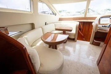 Ghost Rider Yacht Photos Pics Luxurious interior of 2003 Azimut 74 Solar yacht with elegant seating and wooden accents.