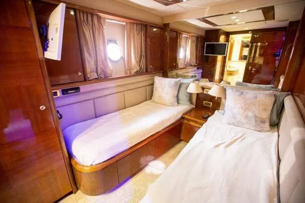 Ghost Rider Yacht Photos Pics Luxurious cabin interior of 2003 Azimut 74 Solar yacht with twin beds and elegant decor.