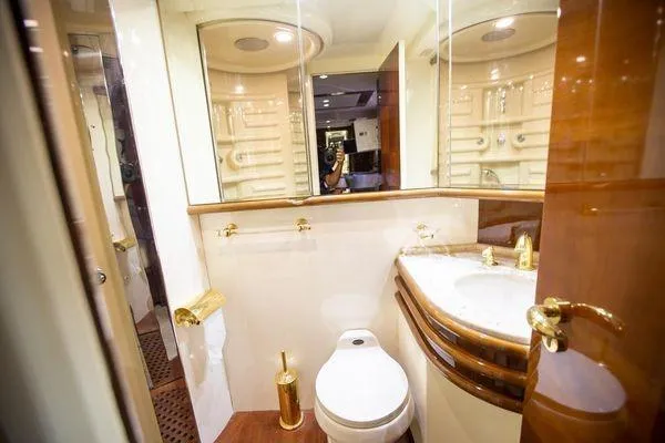 Ghost Rider Yacht Photos Pics Luxurious bathroom in 2003 Azimut 74 Solar yacht with elegant fixtures and mirrored walls.
