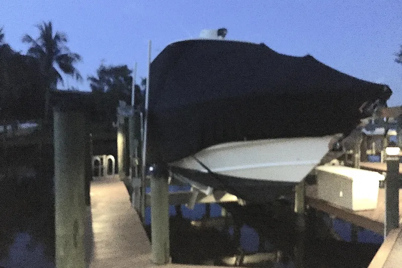 Yacht Photos Pics 2005 Boston Whaler 320 Outrage boat docked at twilight, fully covered and secured.