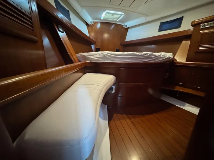 Sanctuary Yacht Photos Pics Interior of 2005 Beneteau Oceanis Clipper 473 yacht with wooden finish and cozy bed.