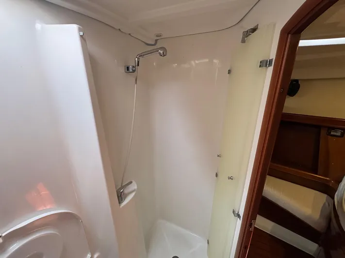 Sanctuary Yacht Photos Pics Shower area in 2005 Beneteau Oceanis Clipper 473 yacht, featuring sleek white interior.