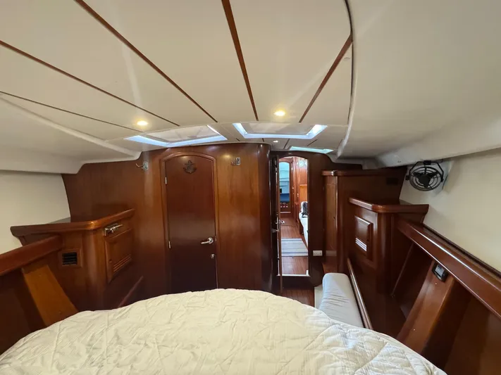 Sanctuary Yacht Photos Pics Interior of 2005 Beneteau Oceanis Clipper 473 yacht, featuring wood paneling and cozy cabin.