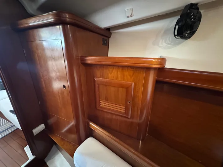 Sanctuary Yacht Photos Pics Interior of 2005 Beneteau Oceanis Clipper 473, featuring wooden cabinetry and seating.